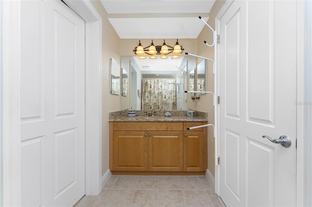 bathroom featuring tile patterned floors, curtained shower, and vanity