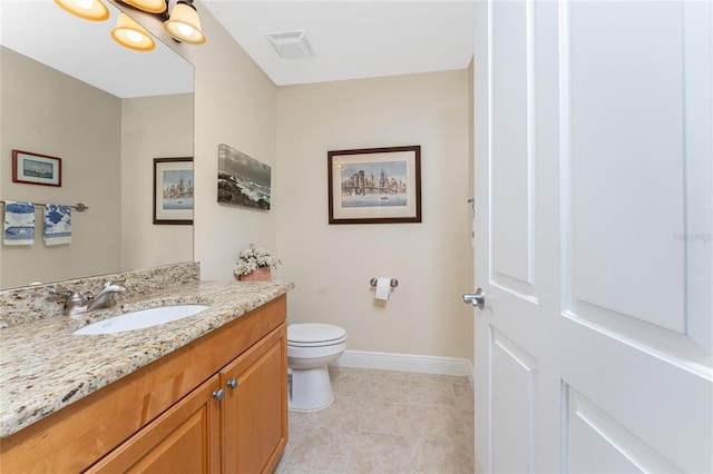 bathroom featuring tile patterned flooring, vanity, and toilet