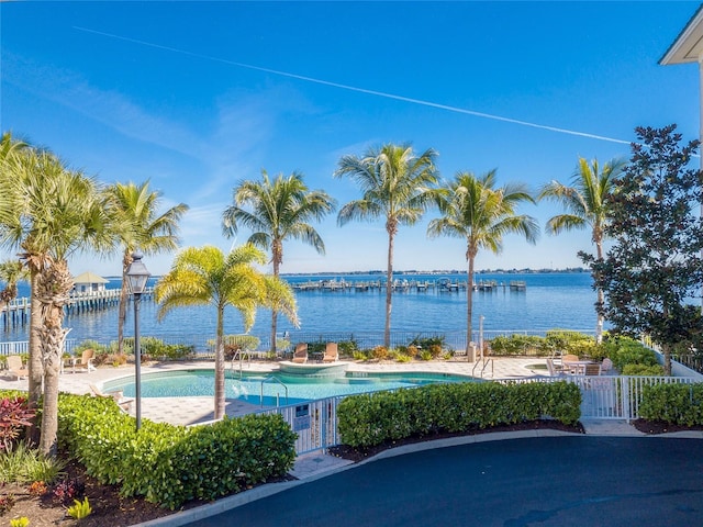 view of swimming pool featuring a water view