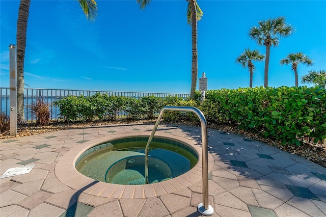 view of swimming pool with an in ground hot tub