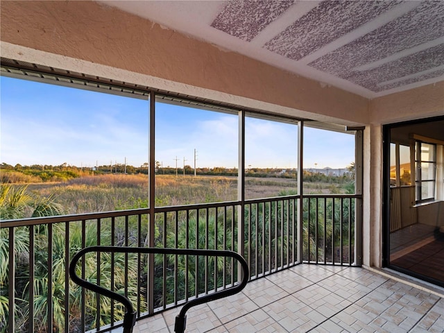 sunroom featuring a rural view