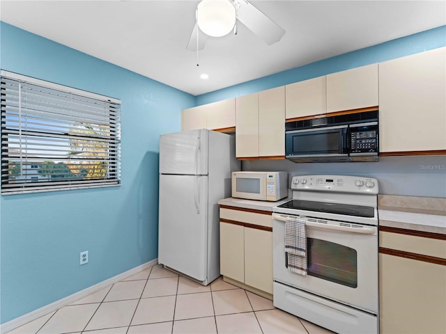 kitchen with cream cabinets, white appliances, light tile patterned floors, and ceiling fan