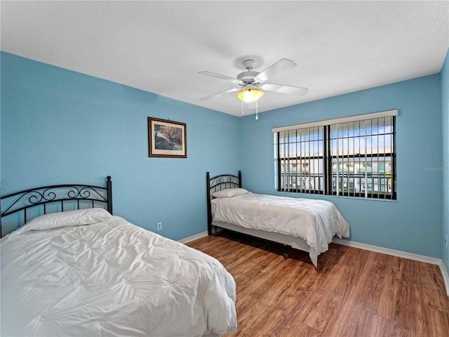 bedroom featuring hardwood / wood-style flooring and ceiling fan