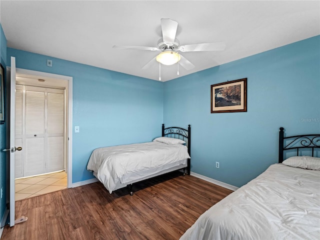 bedroom featuring wood-type flooring, a closet, and ceiling fan