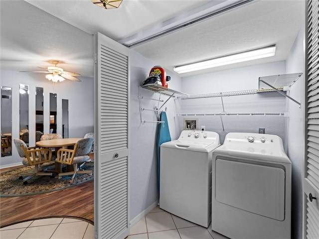 laundry area featuring washer and clothes dryer, ceiling fan, light tile patterned flooring, and a textured ceiling