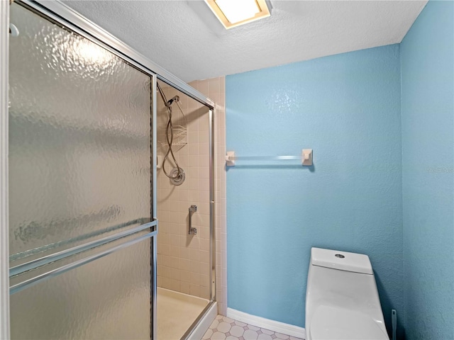 bathroom featuring a textured ceiling, an enclosed shower, and toilet