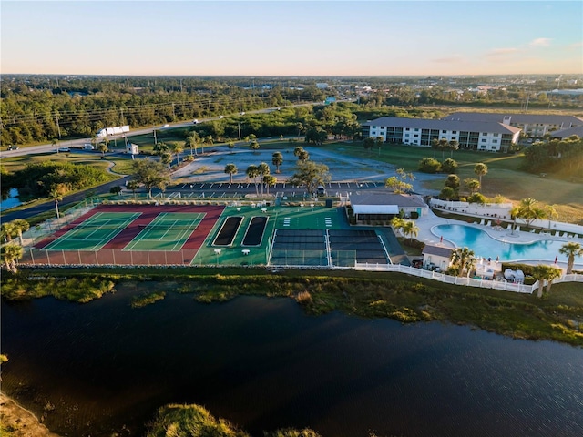 aerial view at dusk featuring a water view