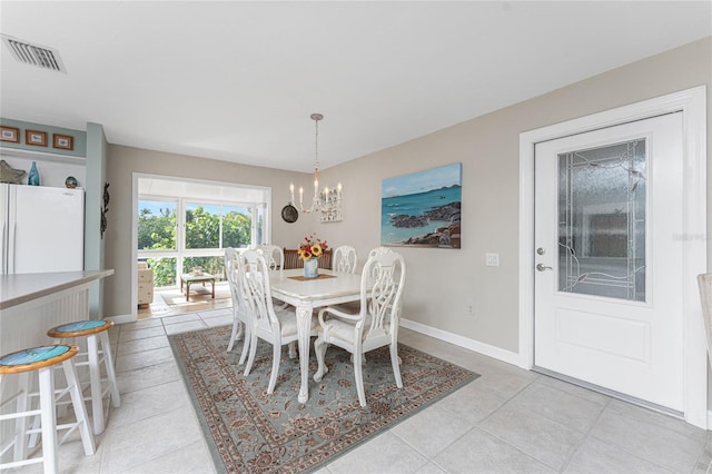 tiled dining room featuring a notable chandelier