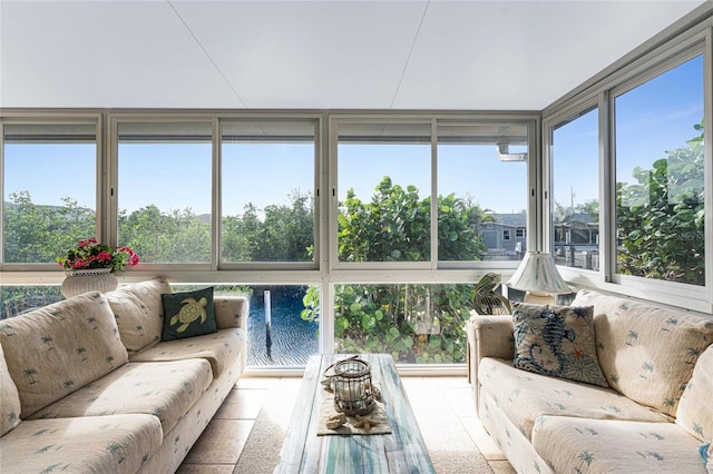 sunroom / solarium with a healthy amount of sunlight and a water view