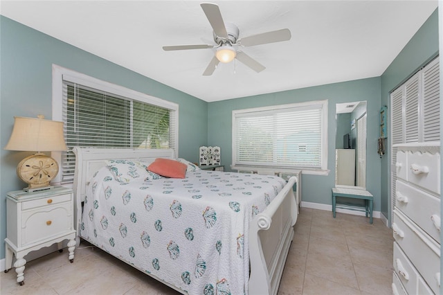 bedroom with ceiling fan and light tile patterned flooring