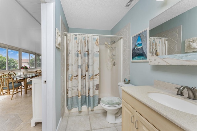 bathroom with a shower with curtain, vanity, toilet, and a textured ceiling