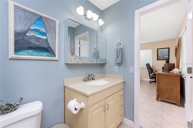 bathroom with tile patterned floors, vanity, and toilet