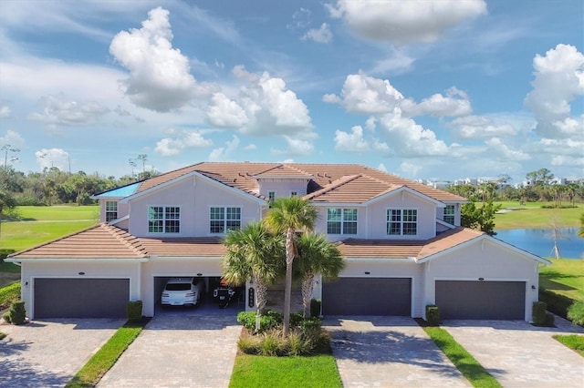 view of front facade featuring a water view and a garage