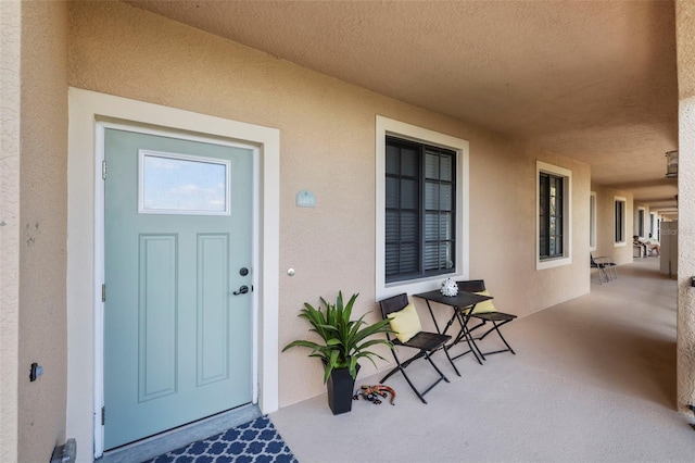 view of exterior entry with covered porch