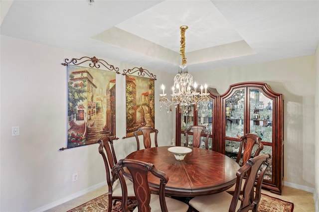 dining area featuring a chandelier and a tray ceiling