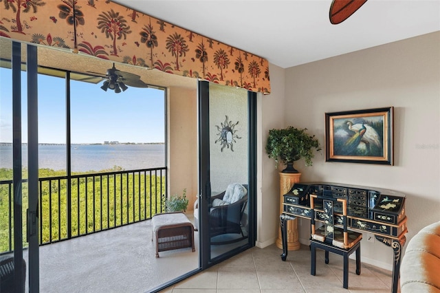 interior space featuring a water view and light tile patterned floors