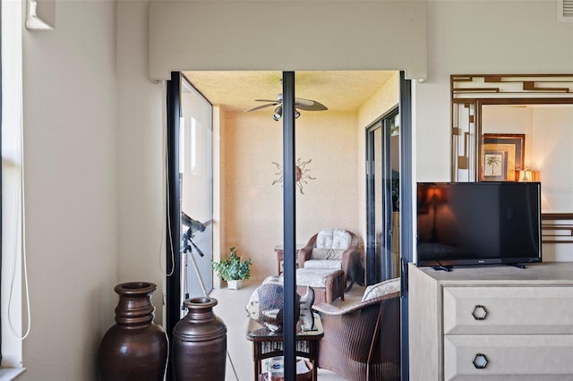 interior space with ceiling fan