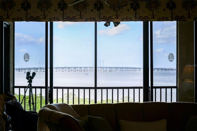 sunroom with plenty of natural light and a water view