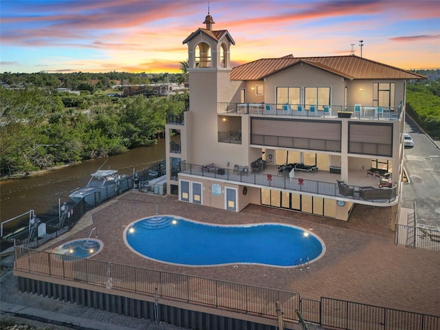 pool at dusk with a patio