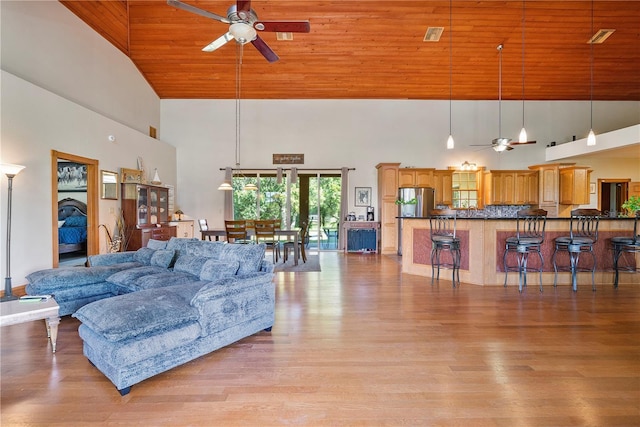 living room featuring ceiling fan, light hardwood / wood-style flooring, high vaulted ceiling, and wood ceiling