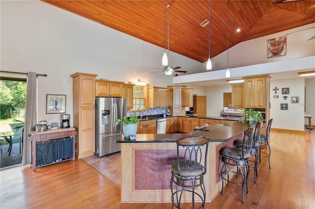 kitchen featuring high vaulted ceiling, ceiling fan, decorative backsplash, appliances with stainless steel finishes, and wood ceiling