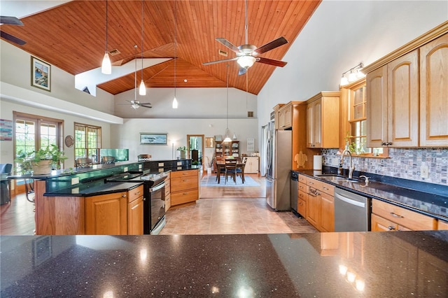 kitchen with appliances with stainless steel finishes, decorative light fixtures, tasteful backsplash, and sink