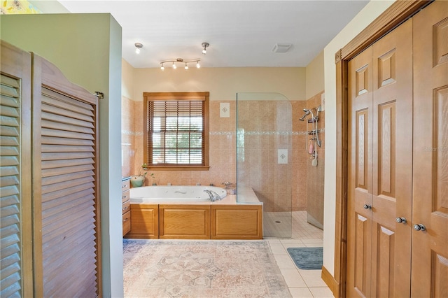 bathroom featuring tile patterned floors and independent shower and bath