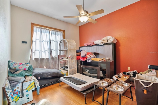 bedroom with ceiling fan and wood-type flooring