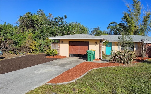 single story home featuring a garage and a front lawn