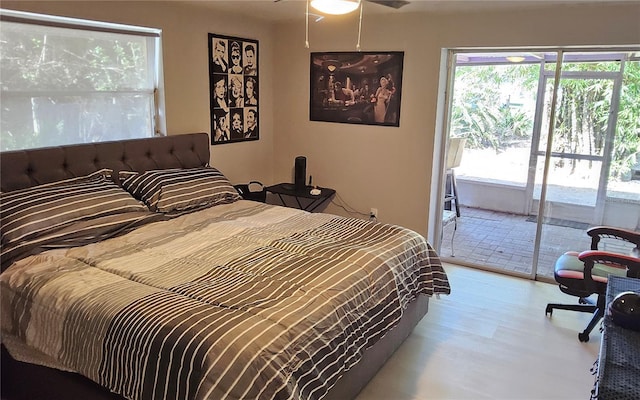 bedroom featuring access to exterior and light hardwood / wood-style floors