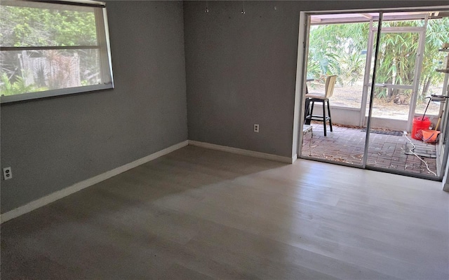 1108 Ample Ave, Port Charlotte, FL 33948 - unfurnished room featuring baseboards, healthy amount of natural light, and wood finished floors