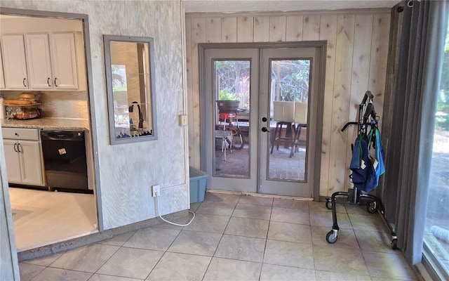 1108 Ample Ave, Port Charlotte, FL 33948 - entryway with french doors, wooden walls, and light tile patterned floors