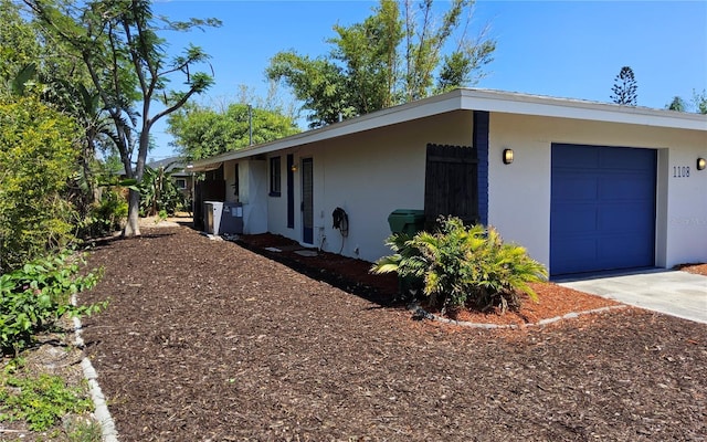 1108 Ample Ave, Port Charlotte, FL 33948 - view of home's exterior with stucco siding, concrete driveway, and an attached garage