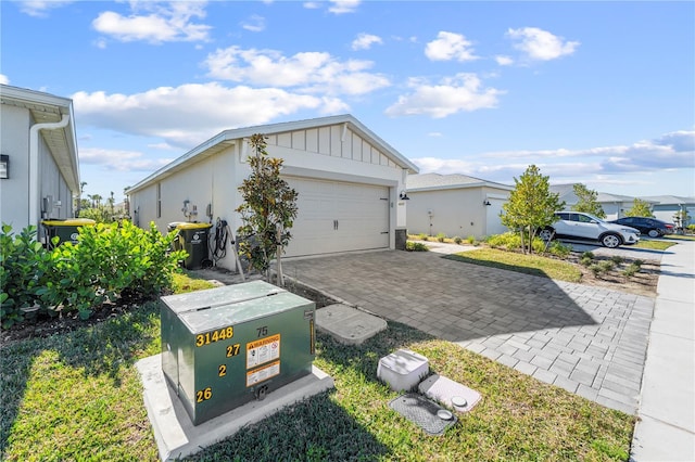 view of side of home featuring a garage and an outbuilding