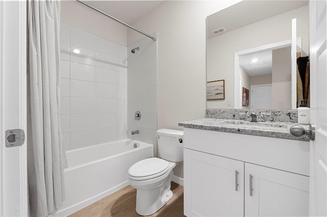 full bathroom featuring vanity, toilet, wood-type flooring, and shower / tub combo with curtain