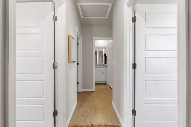 corridor with light hardwood / wood-style floors