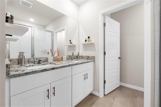 bathroom with vanity and walk in shower