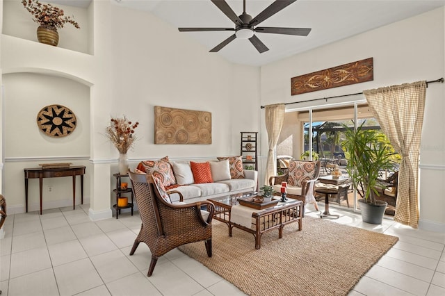 living room featuring light tile patterned floors, a towering ceiling, and ceiling fan