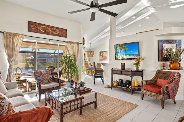 living room with ceiling fan, light tile patterned floors, and vaulted ceiling