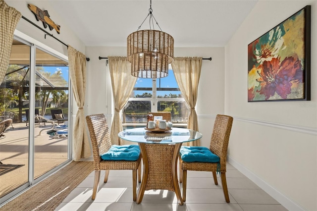 dining room featuring plenty of natural light, light tile patterned floors, and a chandelier