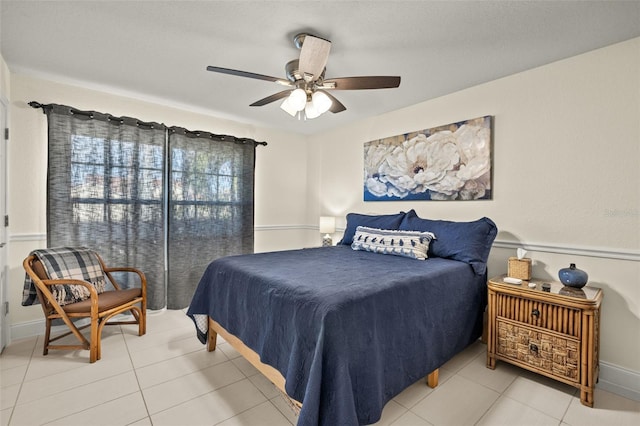 tiled bedroom featuring ceiling fan