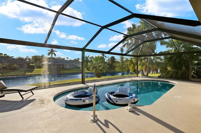 view of swimming pool with a patio, a water view, and glass enclosure