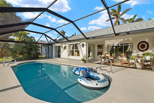 view of pool featuring glass enclosure and a patio