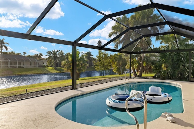 view of pool with glass enclosure, a water view, and a patio