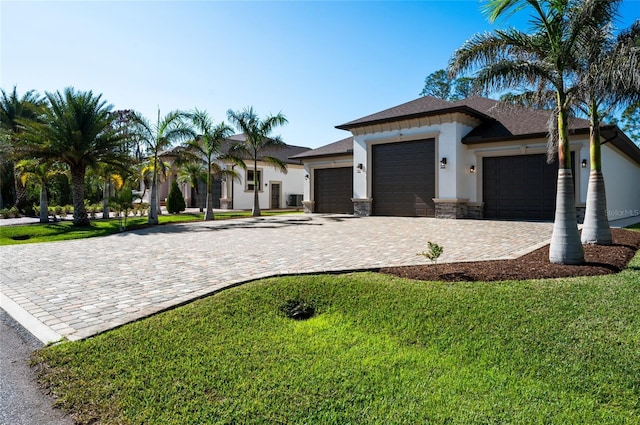 view of front of home with a front lawn and a garage