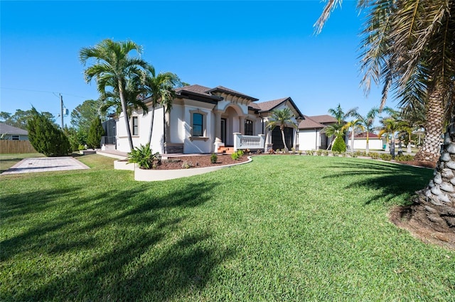 view of front of property with a garage and a front lawn