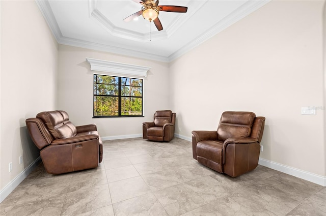 living area with a raised ceiling, ceiling fan, and ornamental molding