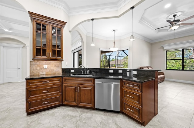 kitchen featuring pendant lighting, dishwasher, dark stone counters, sink, and ceiling fan