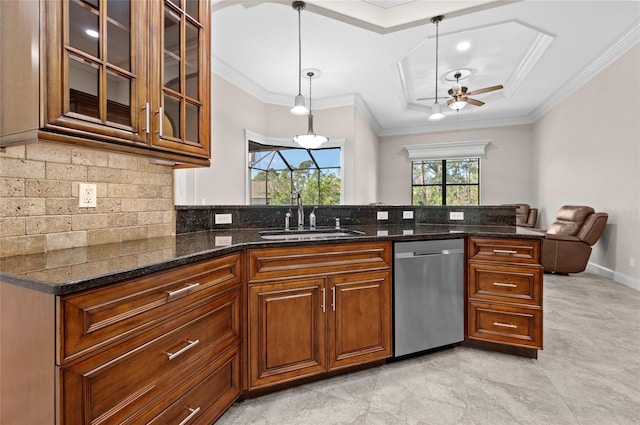 kitchen with ceiling fan, dishwasher, sink, hanging light fixtures, and dark stone counters