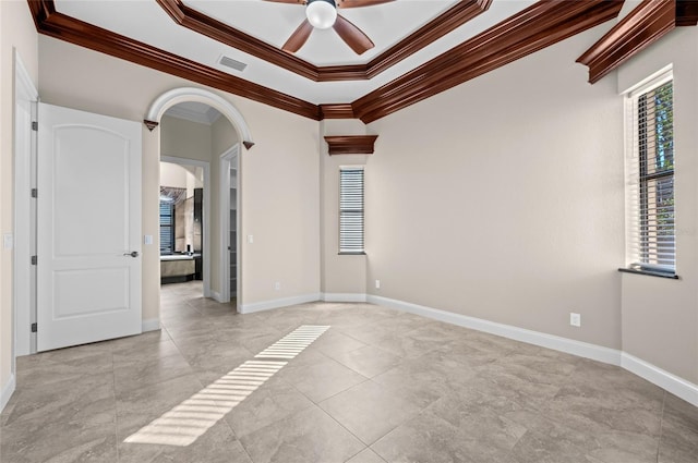 unfurnished room featuring a wealth of natural light, ceiling fan, and ornamental molding